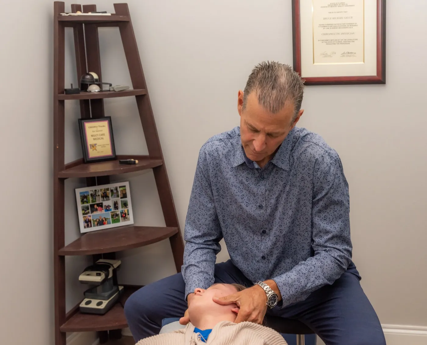 Multi-Care Medical chiropractor performing a hands-on neck adjustment