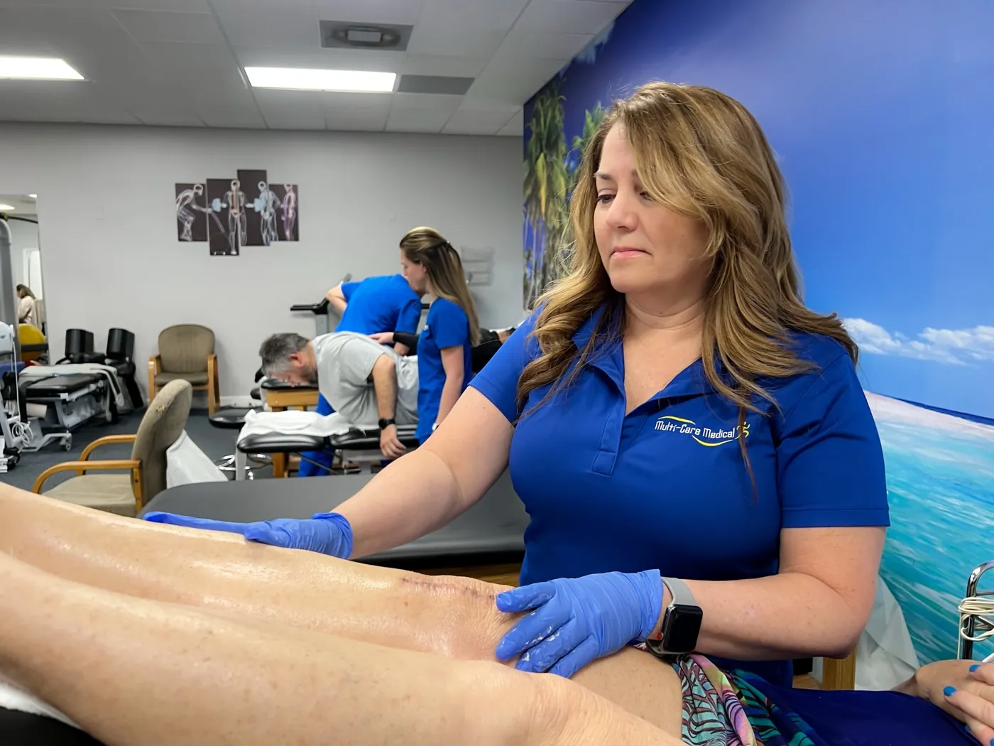 Multi-Care Medical provider assessing a patient’s knee after surgery