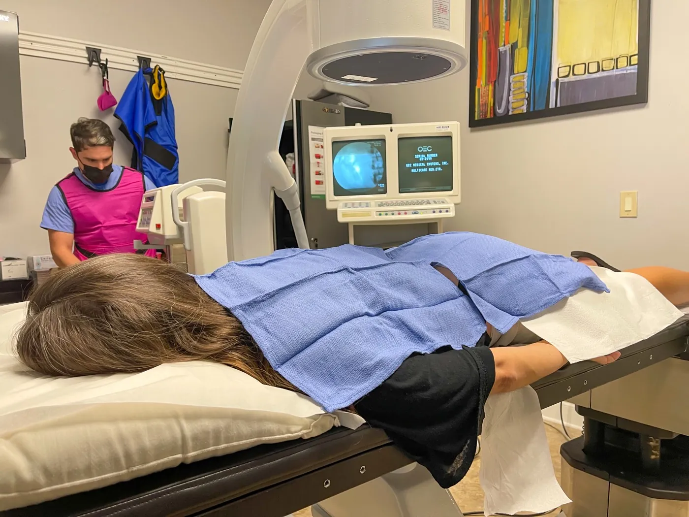 Multi-Care Medical provider performing an image-guided injection procedure under fluoroscopy