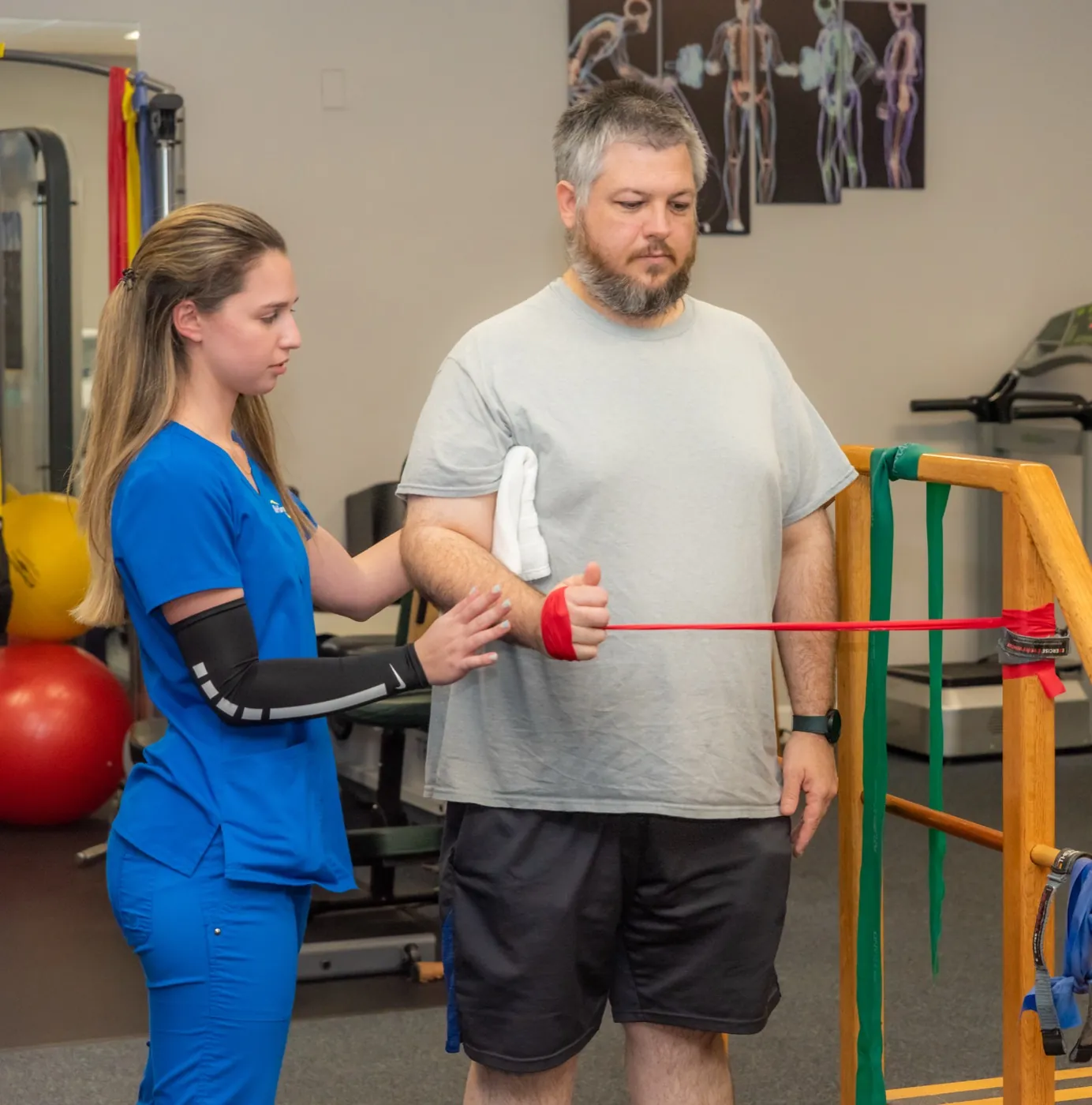 Multi-Care Medical therapist guiding a patient through resistance band exercises